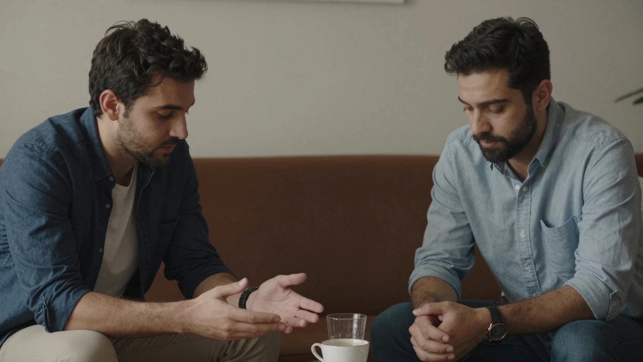 Two men sitting calmly across from each other in a softly lit room, one listening intently.